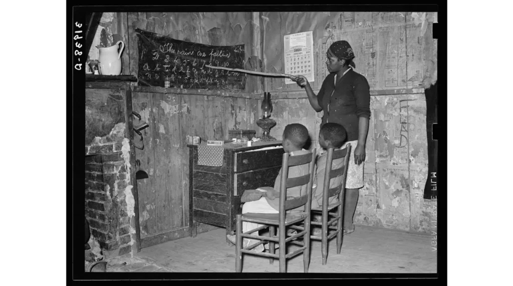 black woman teaching her children numbers and alphabet in Louisiana