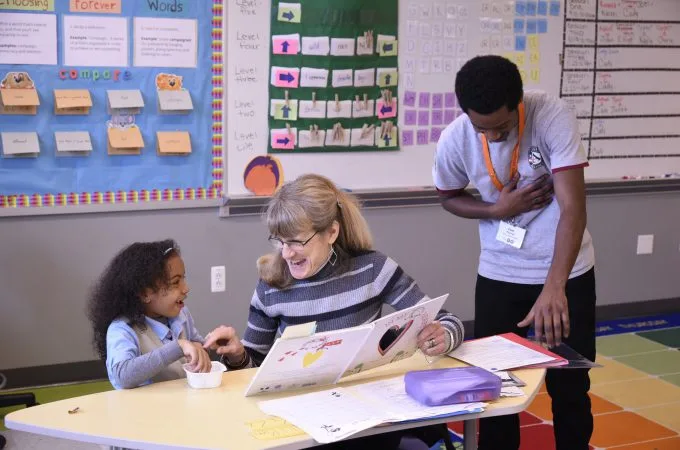 student-tutor pair and an americorps member laughing