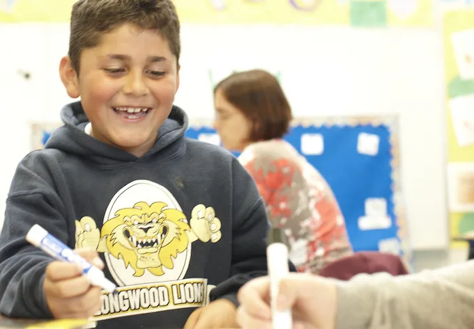 student with dry erase marker