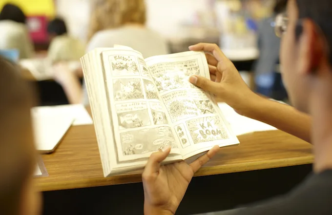 student-tutor pair reading a book