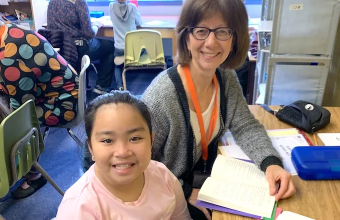 student-tutor pair working on a literacy lesson