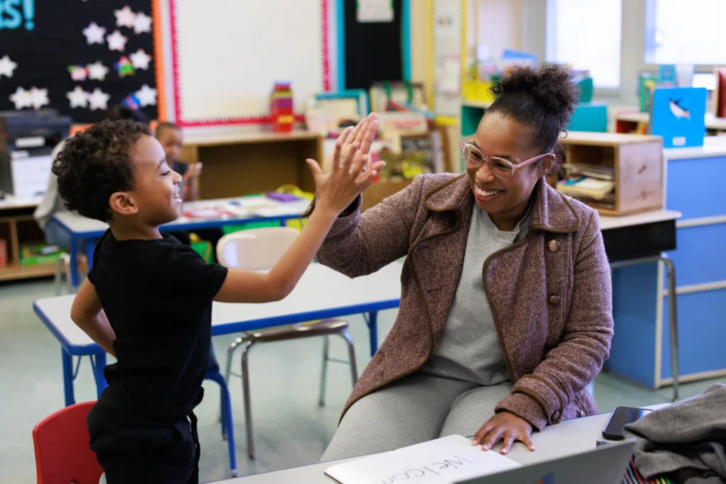 volunteer and student high-fiving