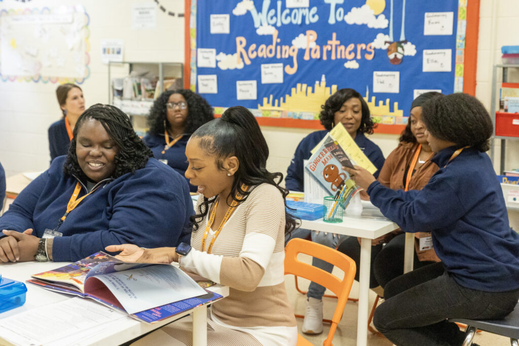 a group of reading partners employees learning about our curriculum