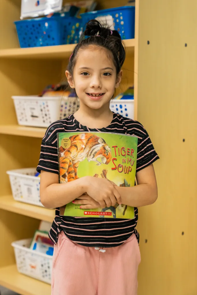 a student holding her favorite book