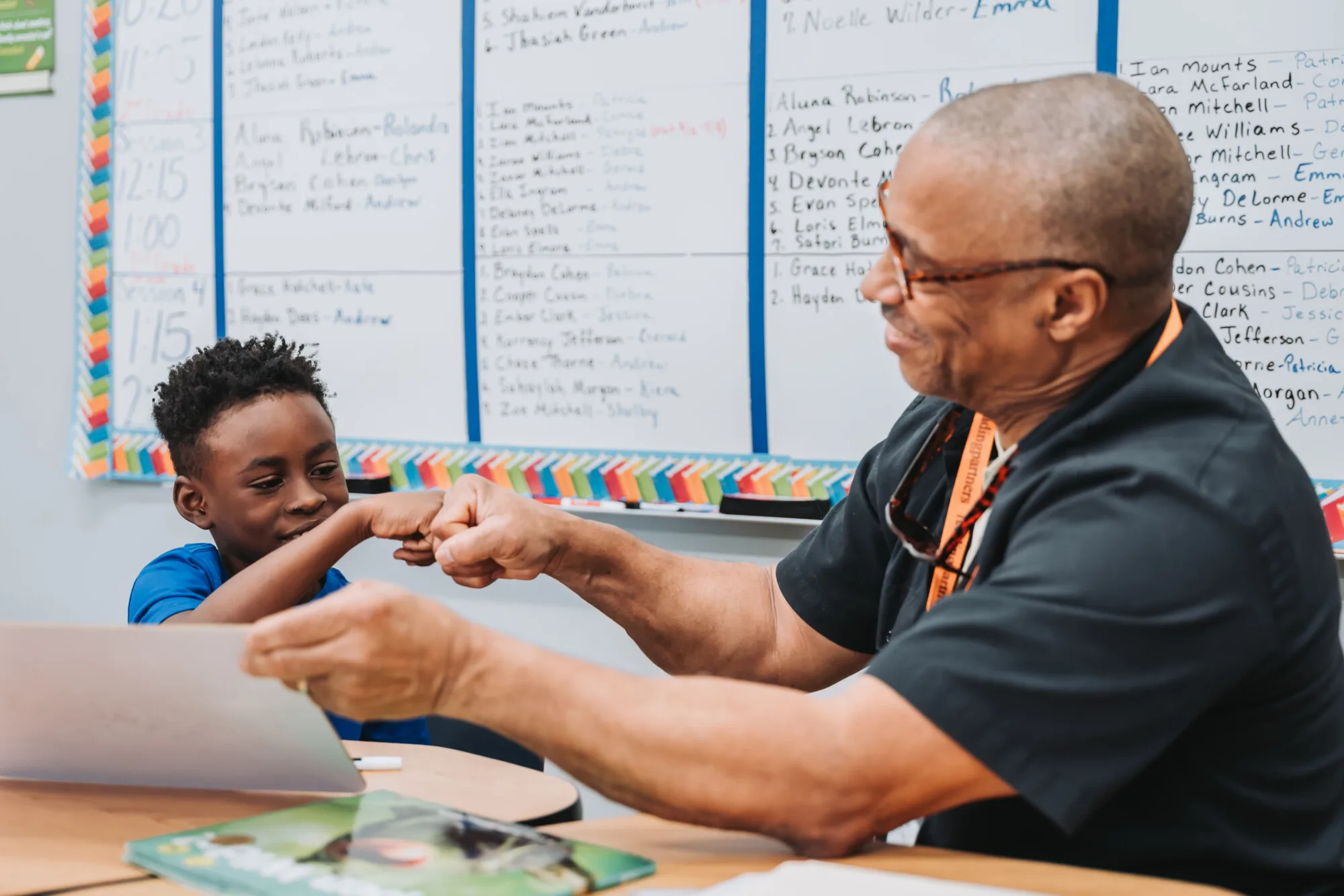 a tutor fighting off the loneliness epidemic by volunteering his time and fist-bumping a student