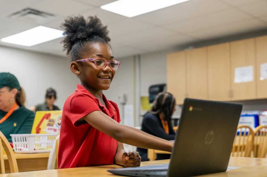 a student pointing at a computer screen
