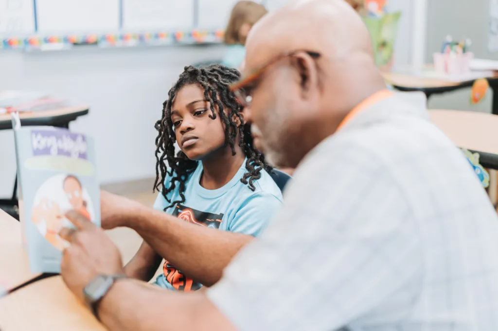 a student and tutor reading together; neurodiversity