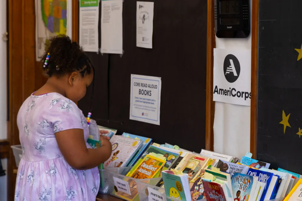a student choosing a book in a reading center