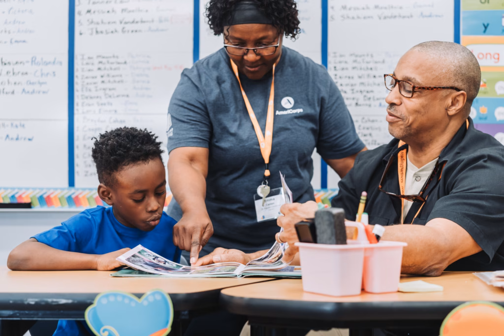 an americorps member helping a student learn to read; dyslexia