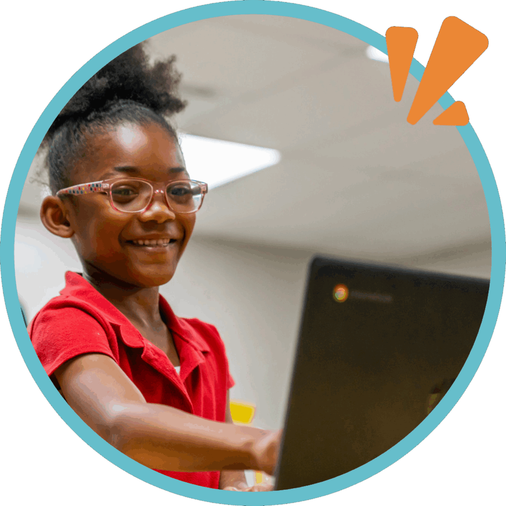 volunteer with brilliant detroit; student pointing at laptop