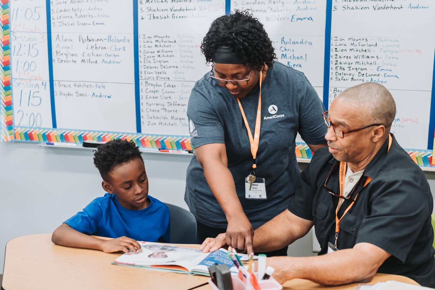 americorps member helping a student read