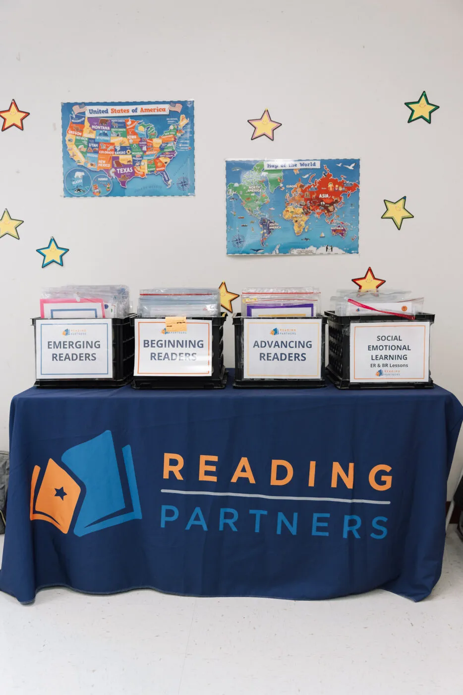 the reading partners curriculum in boxes on a table