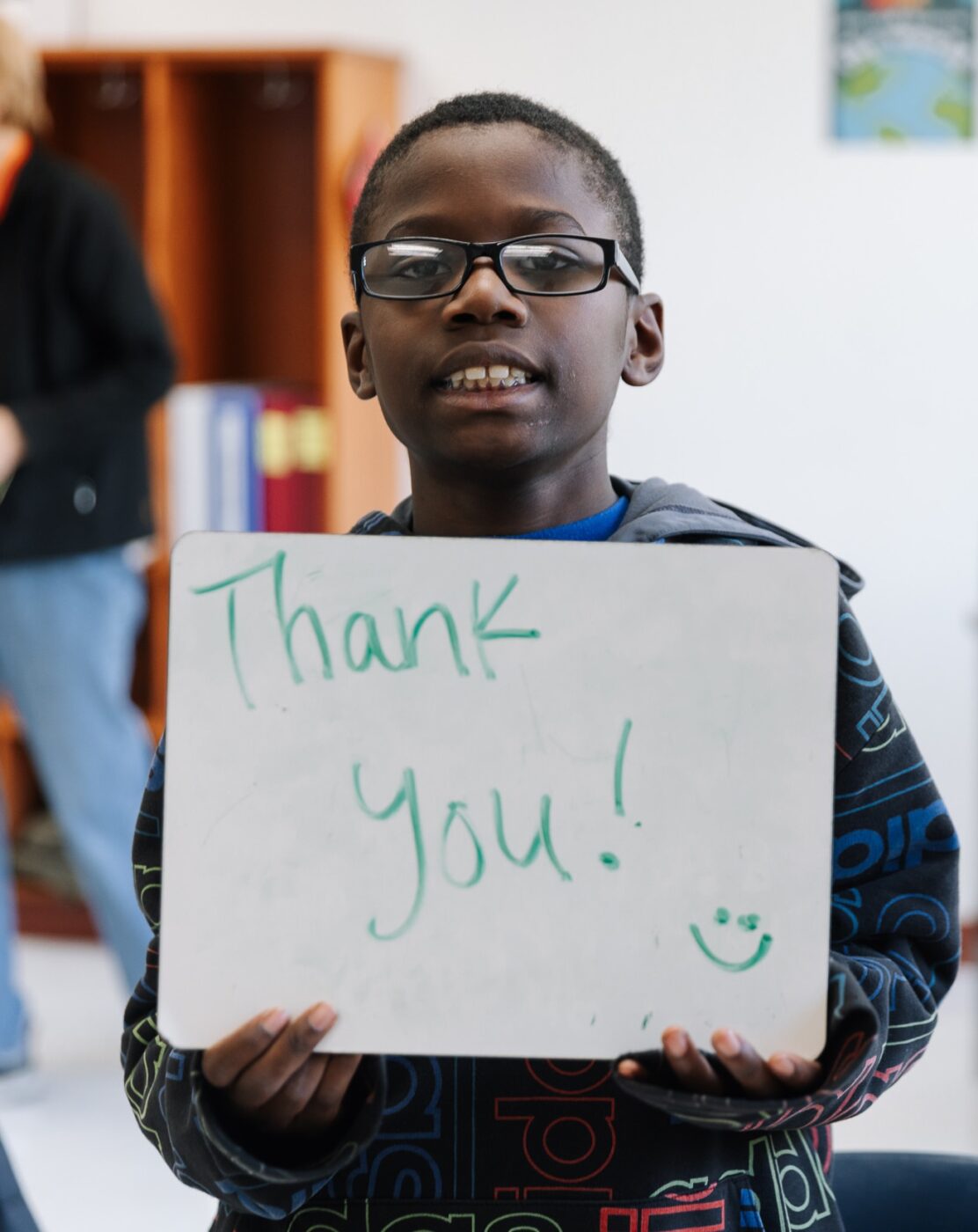 young black student holding up a whiteboard that says 