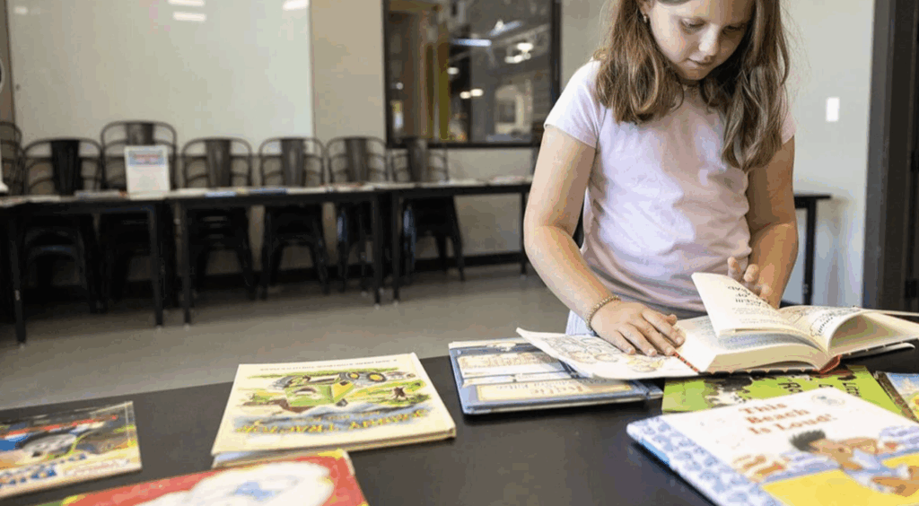 Eva Lemaster, 6, is pictured in August at a Reading Partners book swap event. The program is expanding at Union Public Schools, where 250 students are on a waiting list for tutors, after Tulsa Public Schools ended its Reading Partners program in 2025.